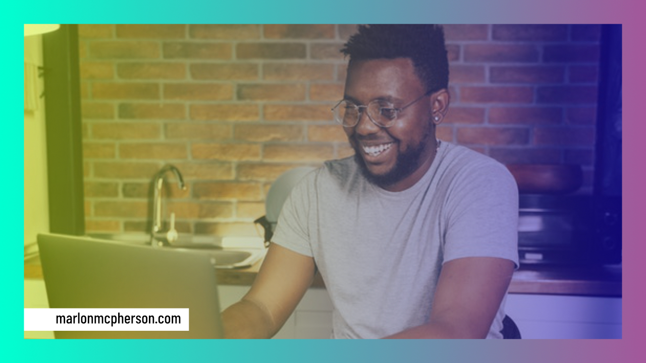 man typing on laptop in kitchen